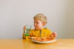How do I train my toddler to self-feed?